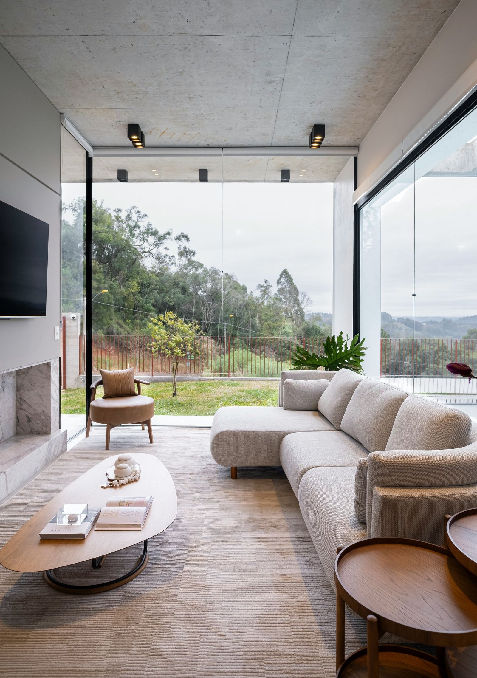 Sunlit living space framed by full-height glazing
