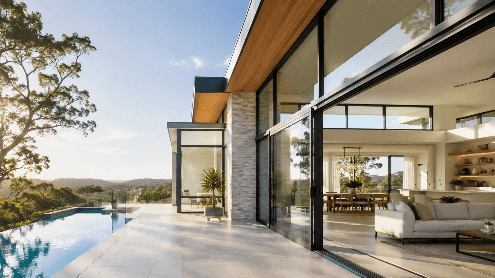 Full-height glazing framing a living room and bushland view